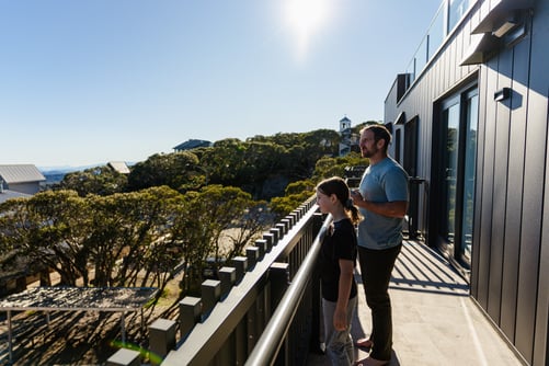 FLOW image credit:FLOW|Leach family  family taking in village views on the balcony of Kooroora apartment in summer on Mt Buller