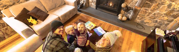 Family time sharing stories and games by the fire is part of the fun of staying in Mt Buller's cosy alpine village