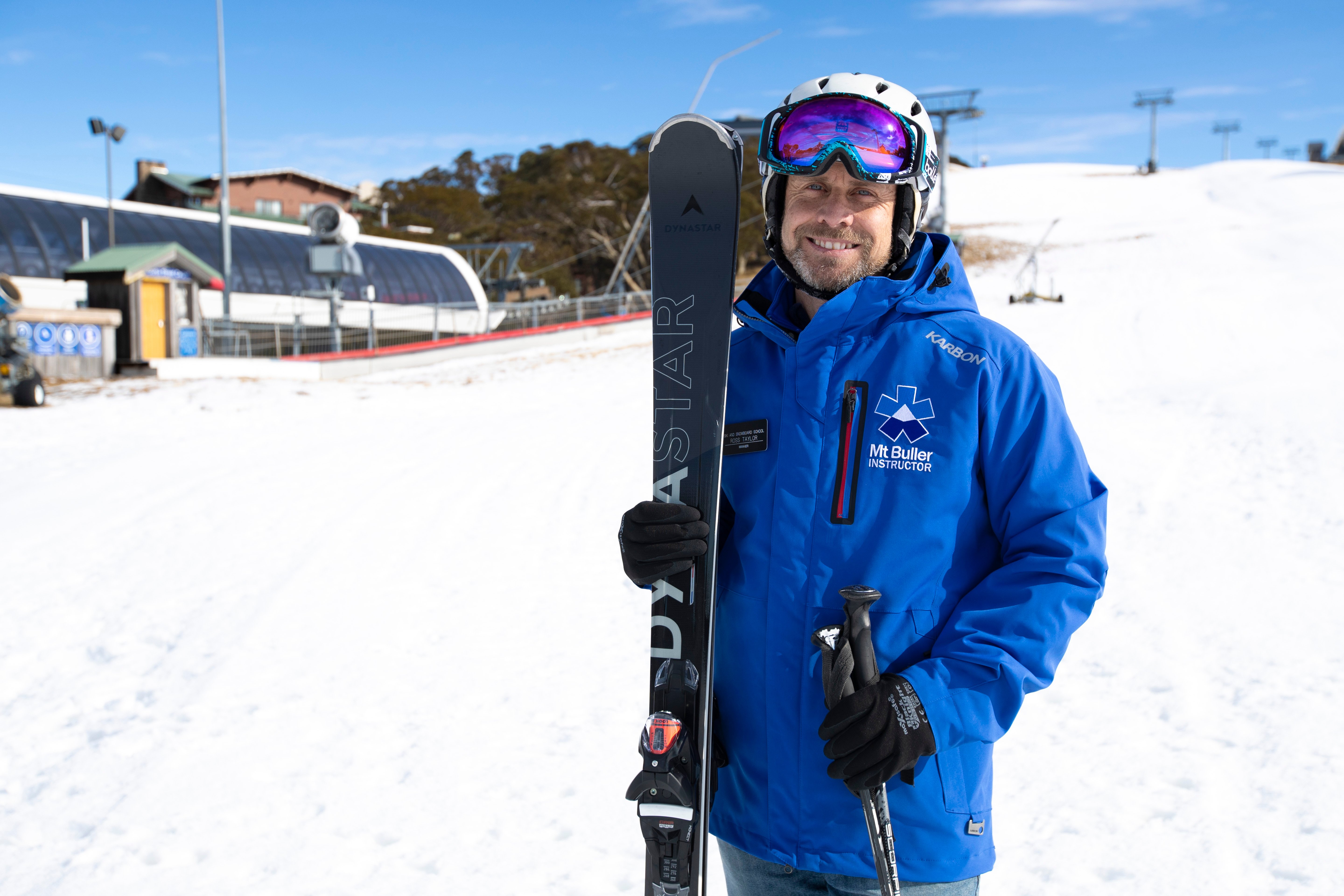 private ski instructor standing with skis