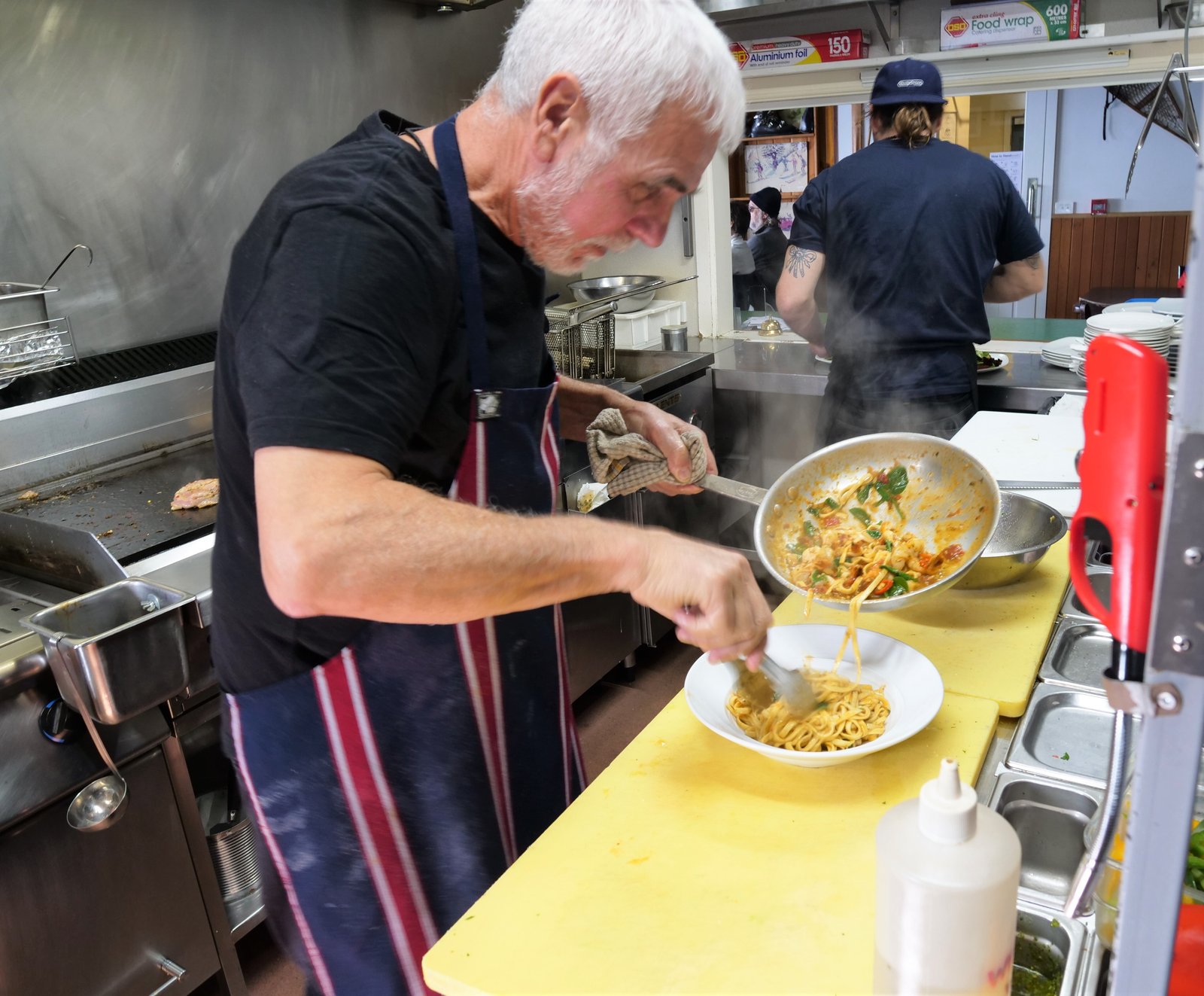 Jimmy serving up fresh made pasta in the Tirol kitchen